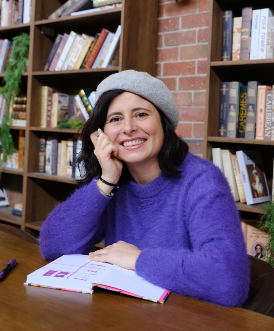designer's profile in a library smiling